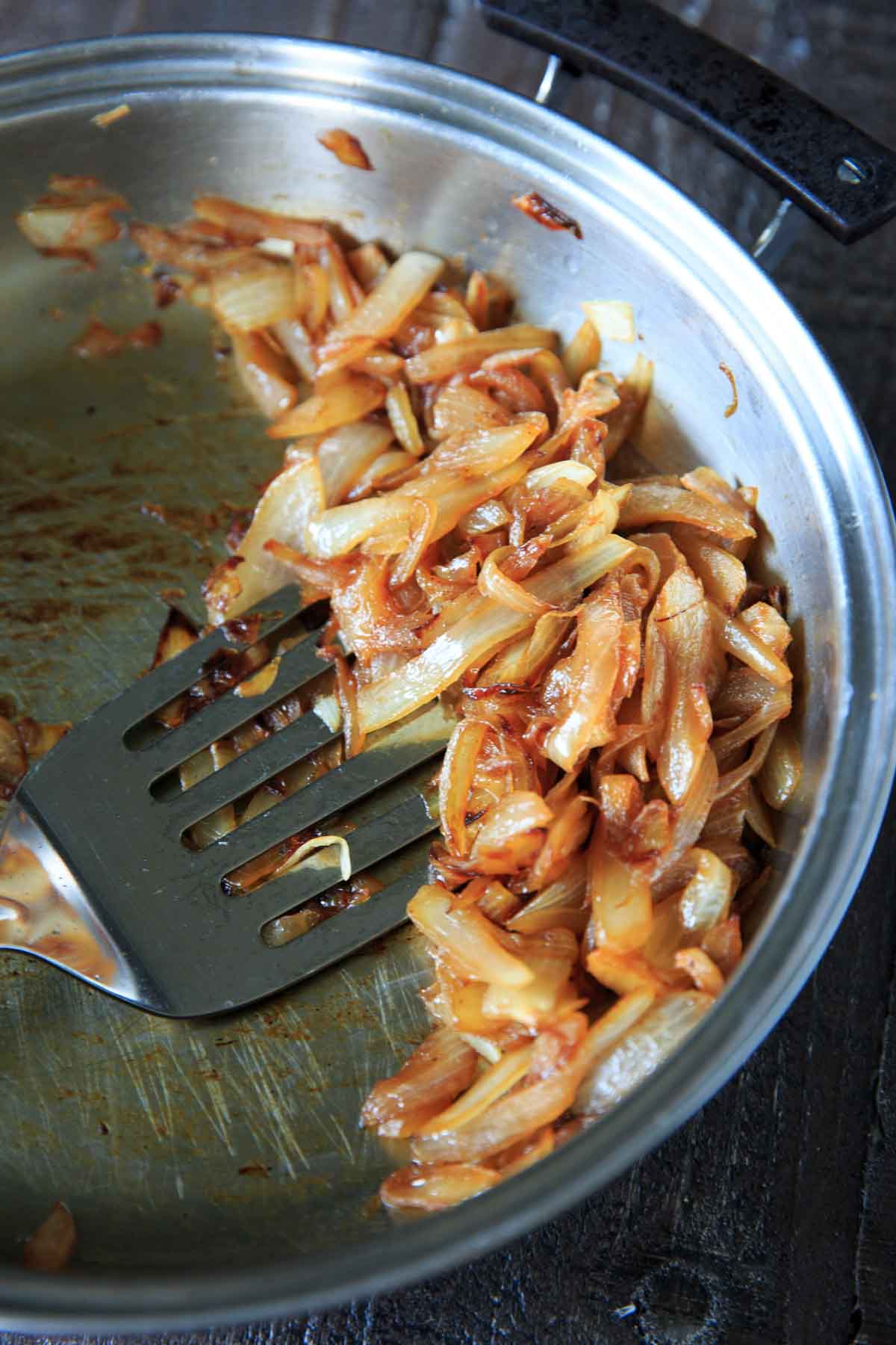 finished caramelized onions in pan with spatula