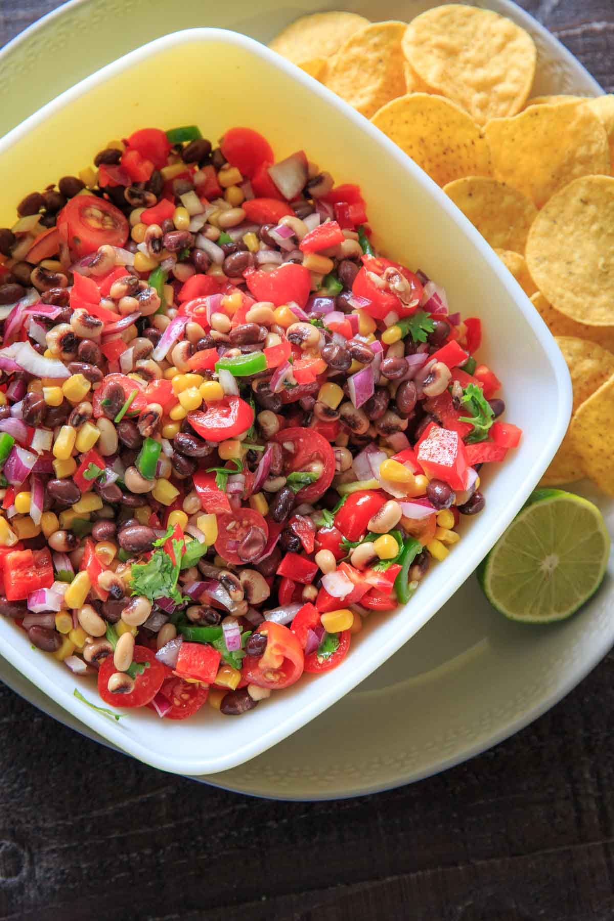 Cowboy (Texas) Caviar with tortilla chips and lime on plate