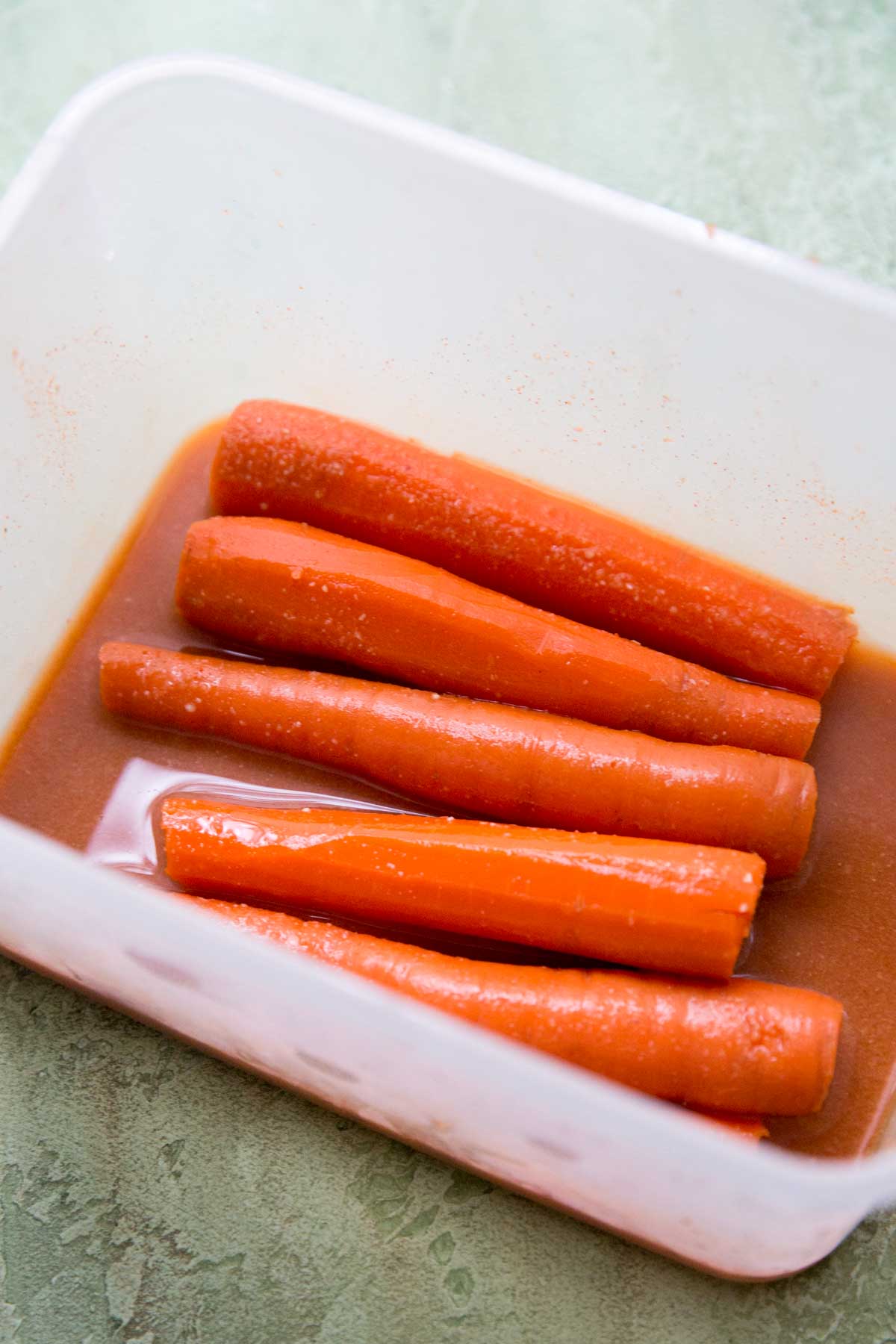 marinating carrots in sauce in plastic container for not dogs 