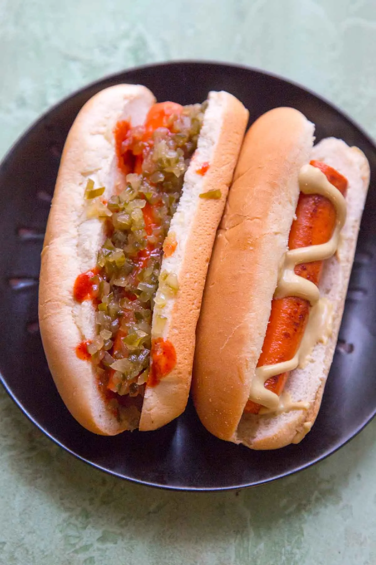 two vegan carrot hot dogs in bun with toppings