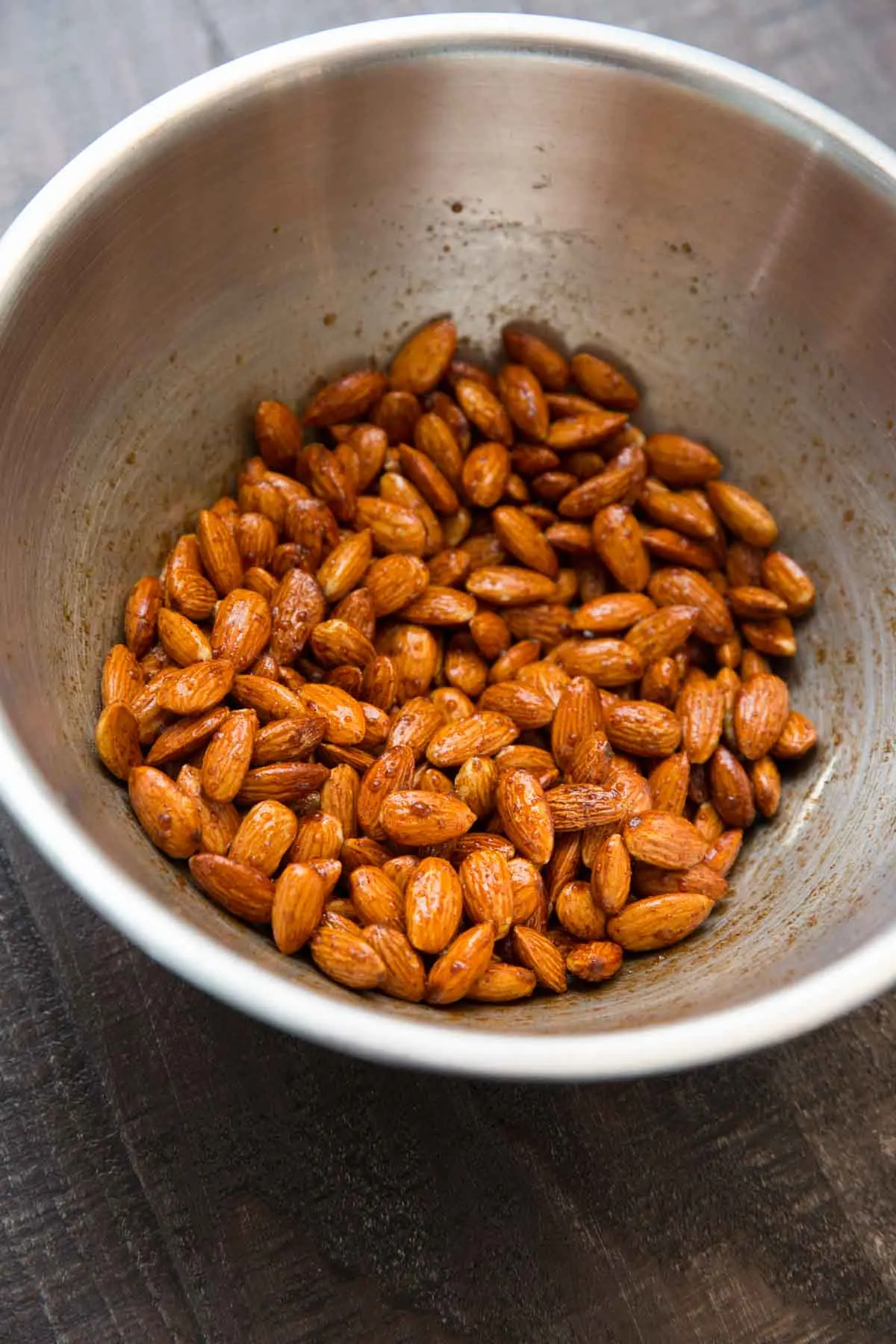 cinnamon honey roasted almonds in mixing bowl