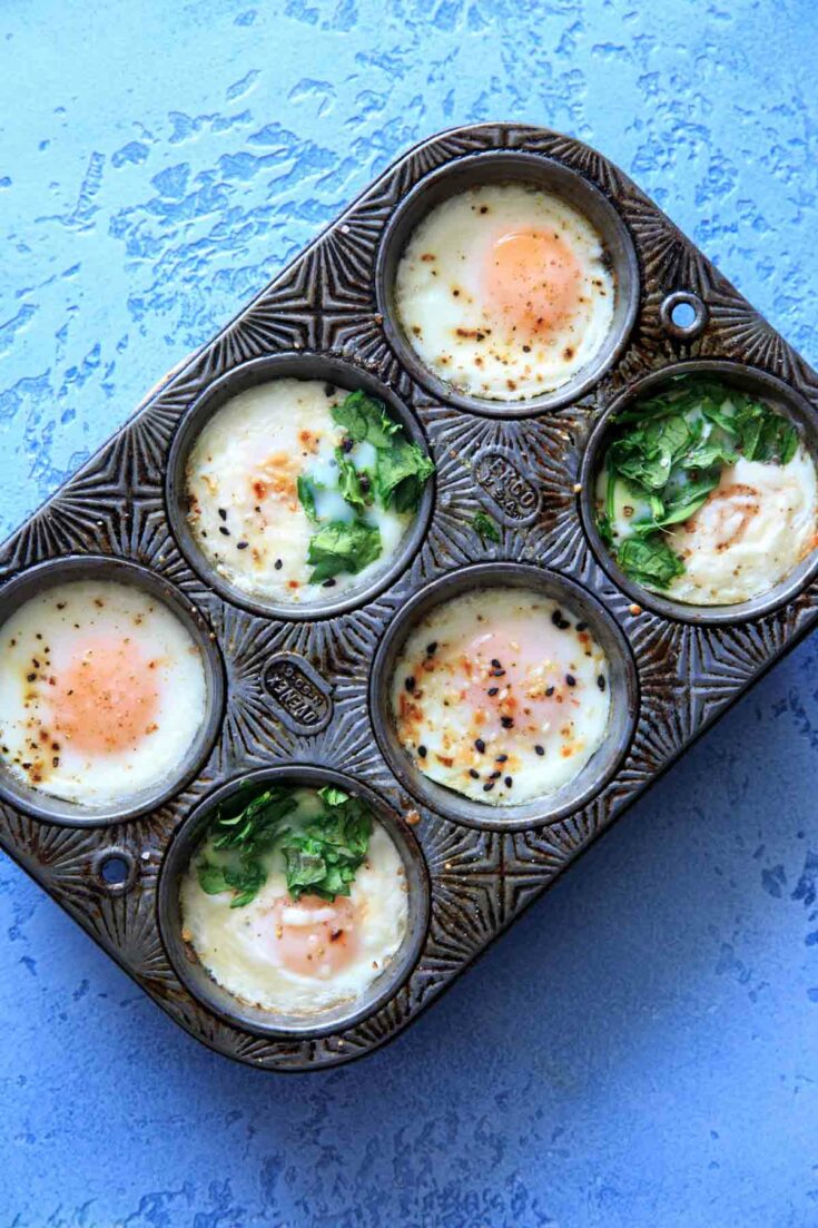 make-ahead egg breakfast cups in a muffin tin - customizing with spinach, cheese and herbs baked