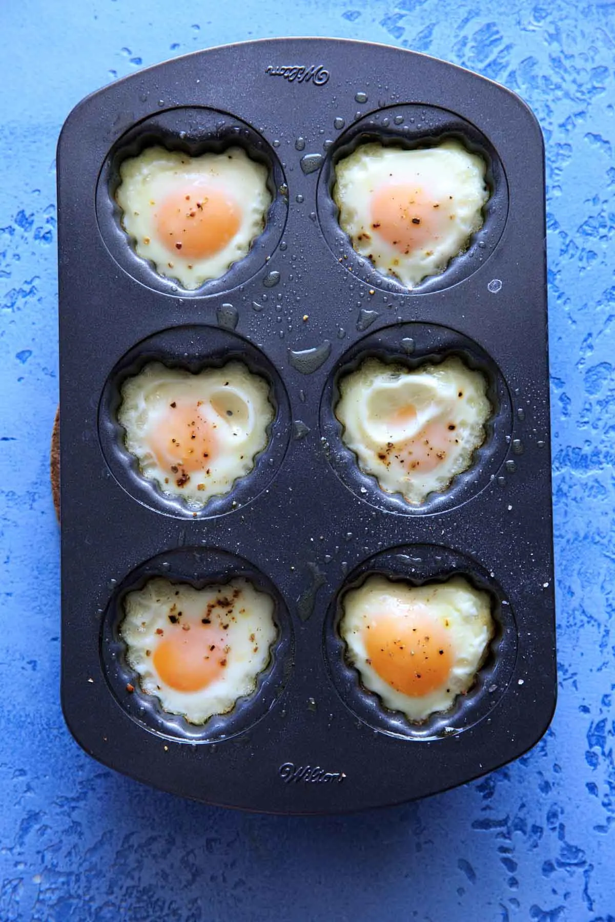 heart shaped egg breakfast cups in a heart muffin pan