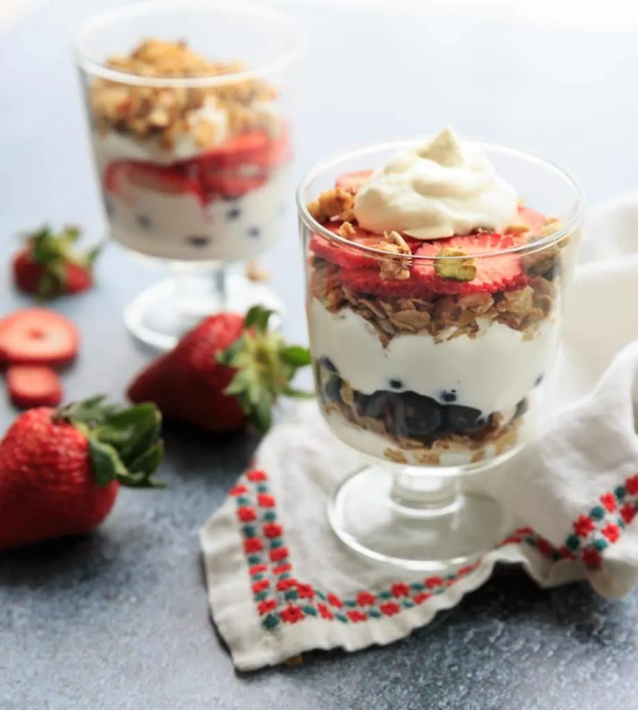 Red, white and blue berry parfait! Layered with yogurt and granola, you'll love this easy recipe for a filling snack or healthy breakfast treat. 