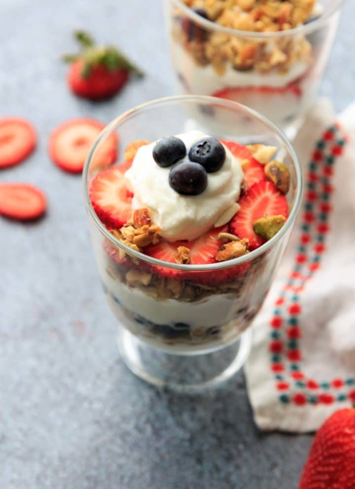Red, white and blue berry parfait! Layered with yogurt and granola, you'll love this easy recipe for a filling snack or healthy breakfast treat.