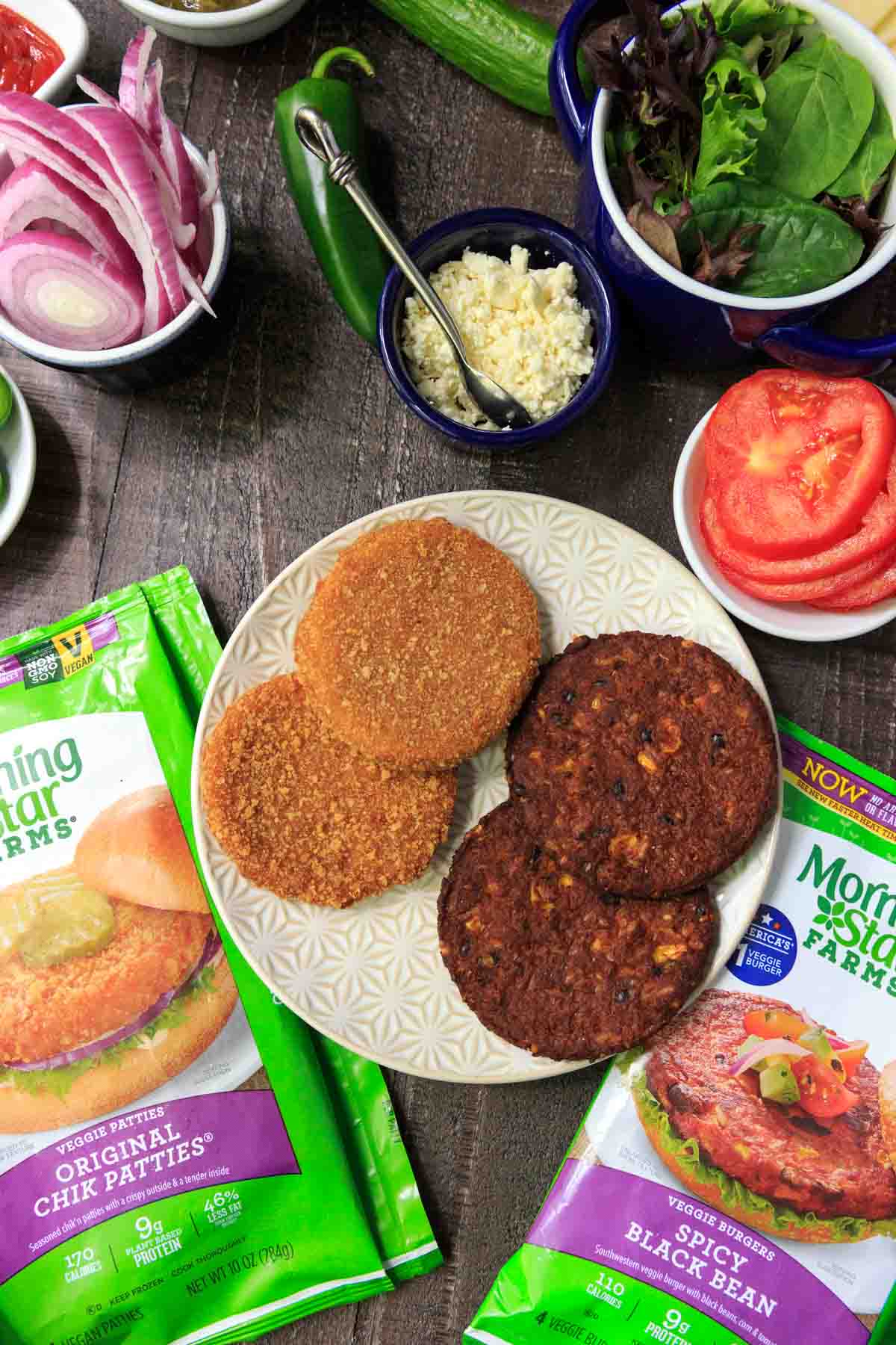 MorningStar burgers on white plate surrounded by toppings in bowls