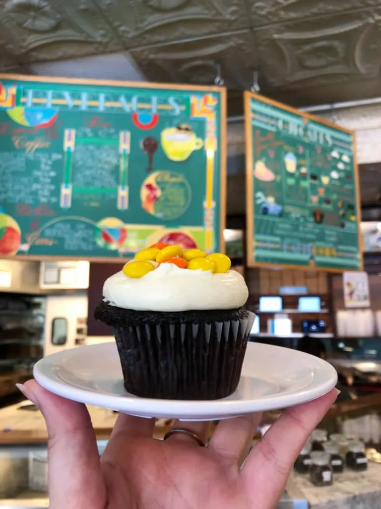 Molly's cupcake - chocolate cream cheese icing and reeses pieces in front of menu