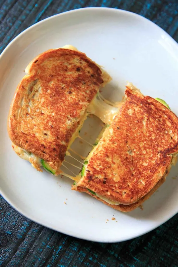 cheese pull from grilled cheese sandwich with zucchini