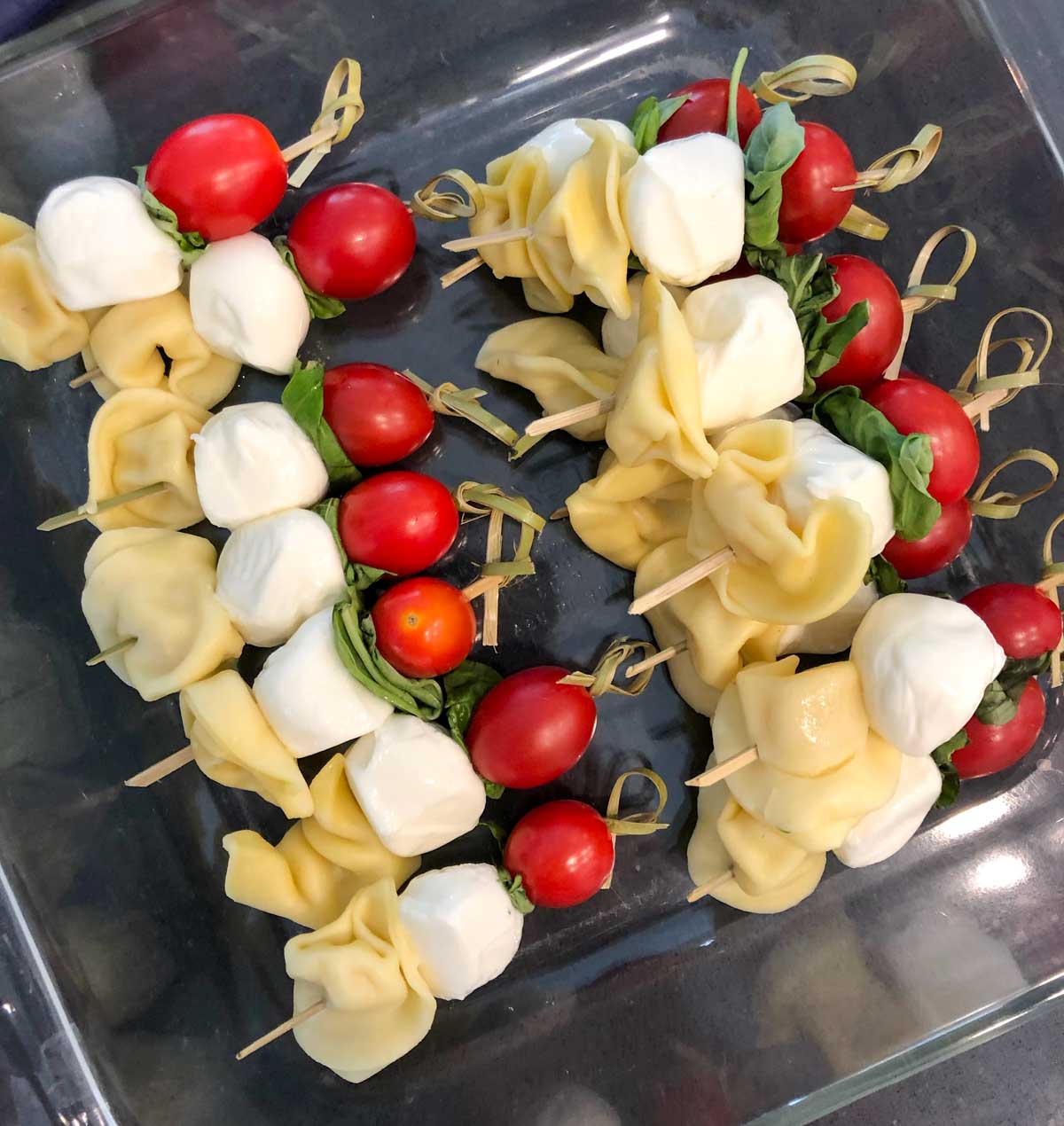 prepping caprese pasta salad skewers