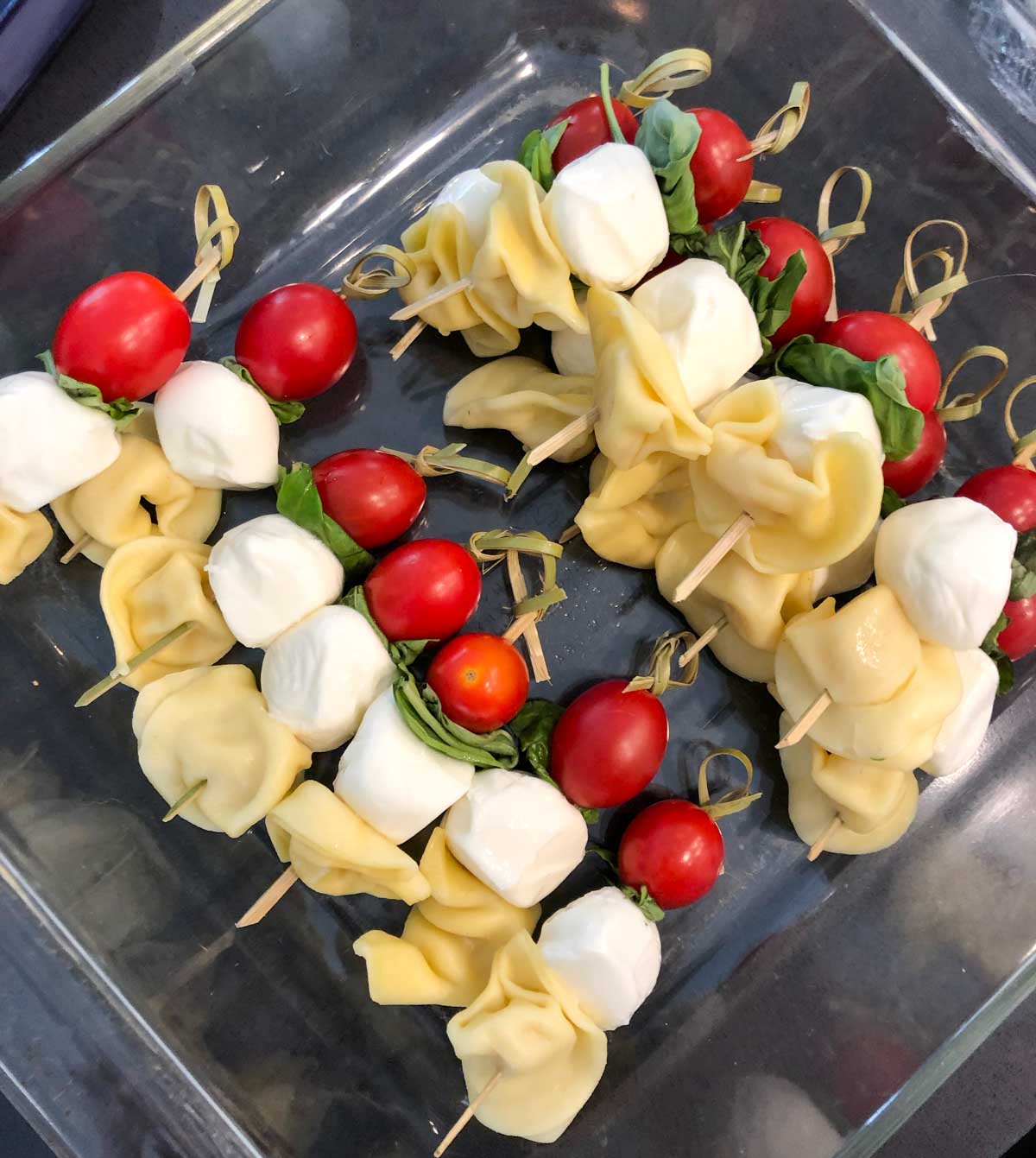 prepping caprese pasta salad skewers