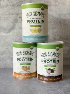 3 canisters of four sigmatic protein powders - peanut butter, sweet vanilla, creamy cacao
