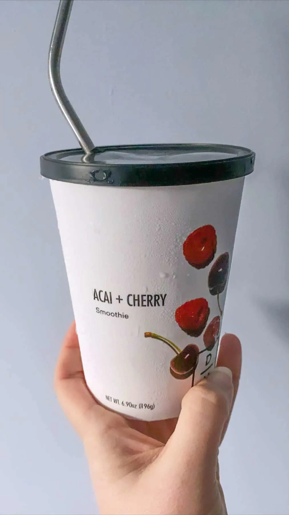 acai and cherry smoothie in daily harvest packaging with straw 
