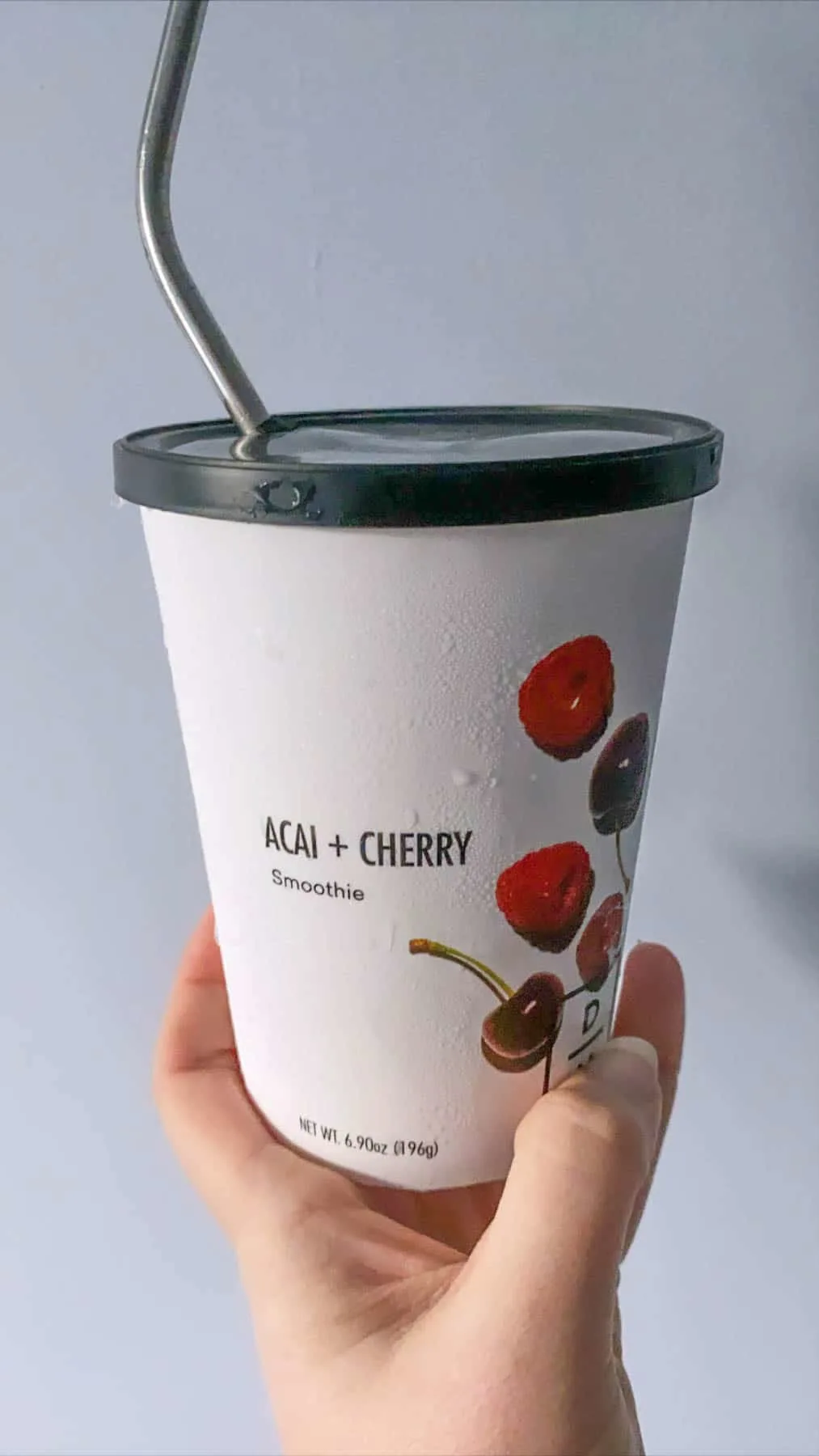 acai and cherry smoothie in daily harvest packaging with straw