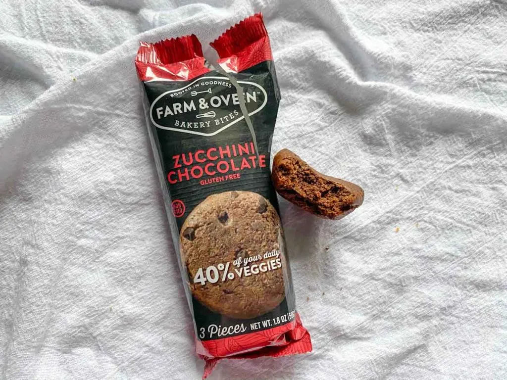 Zucchini chocolate flavor from Farm & oven with a bite out of one muffin