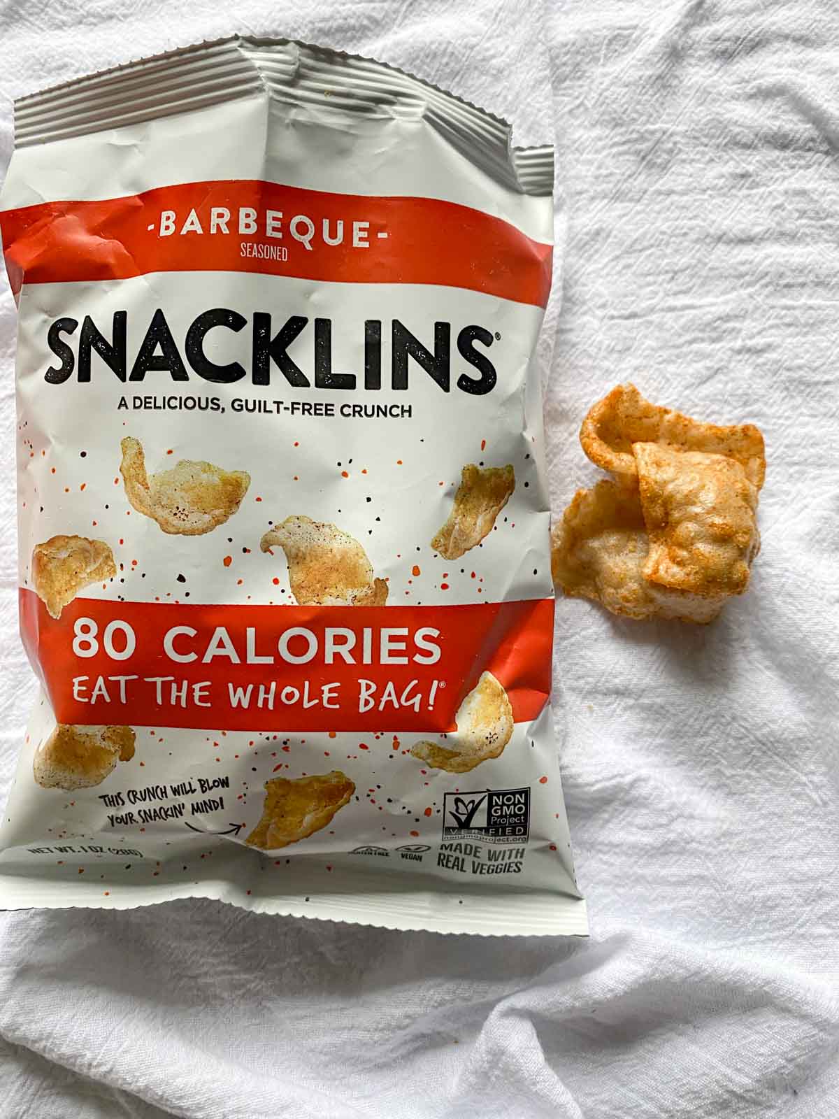 Open bag of snacklins barbeque flavor with chips