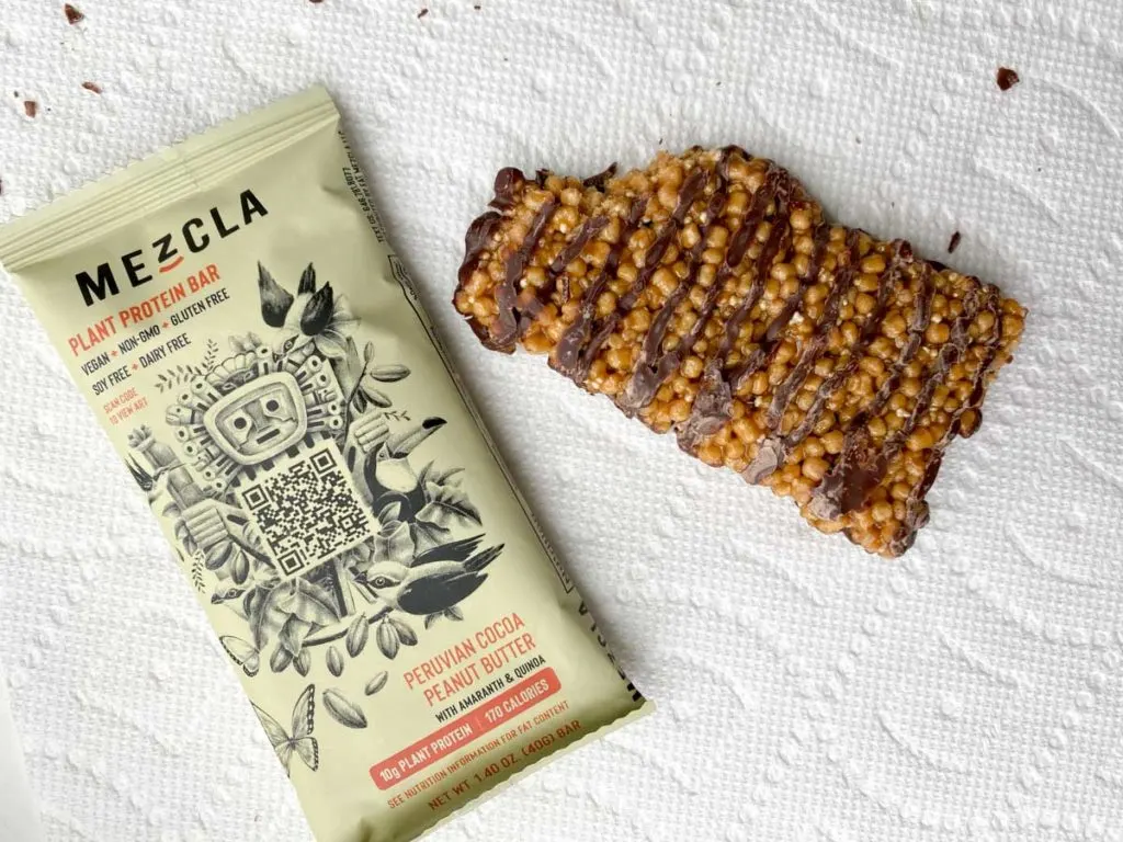 Peruvian Cocoa Peanut Butter flavor of Mezcla plant based bar, bite taken out of it outside of package