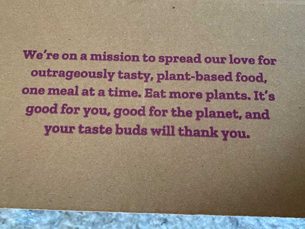 Purple Carrot delivery box mission statement - We're on a mission to spread our love for outrageously tasty, plant-based food, one meal at a time.