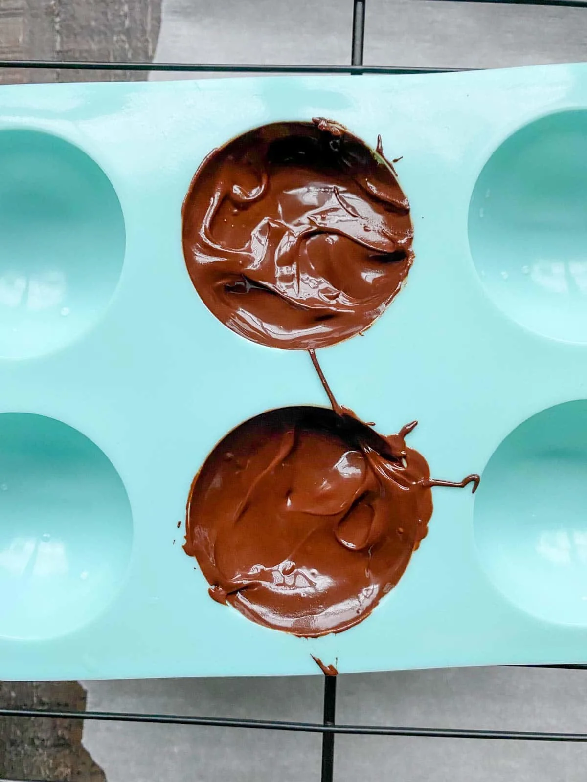 melted chocolate in silicone sphere molds for hot chocolate bombs
