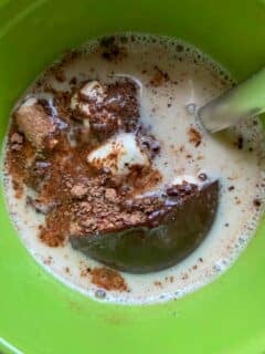 hot cocoa bomb exploding in mug of hot oat milk