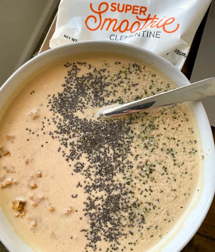 SmoothieBox clementine flavor super-smoothie in a smoothie bowl, topped with chia seeds and granola