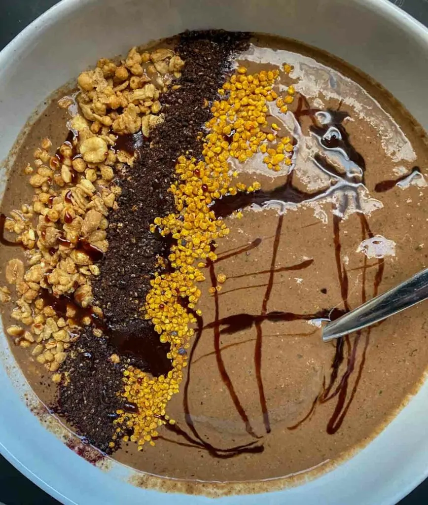 SmoothieBox Cacao flavor super-smoothie in a smoothie bowl, topped with superfoods and cacao honey
