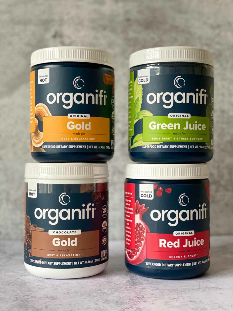 4 tubs of organifi - gold juice powder, green juice powder, chocolate gold powder, red juice powder