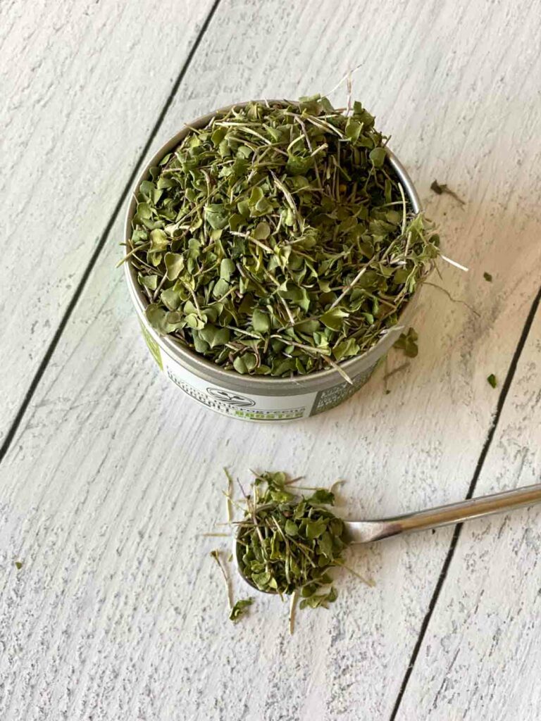 Beyond Microgreens broccolibooster canister with a spoonful next to it