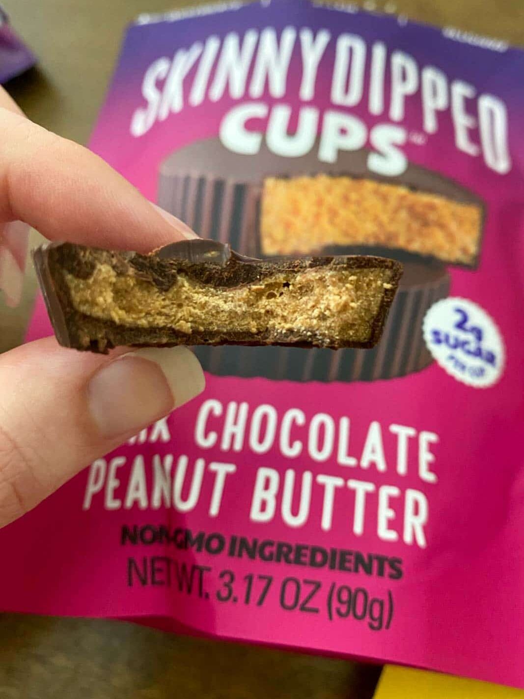 skinny dipped dark chocolate peanut butter cup with bite taken out