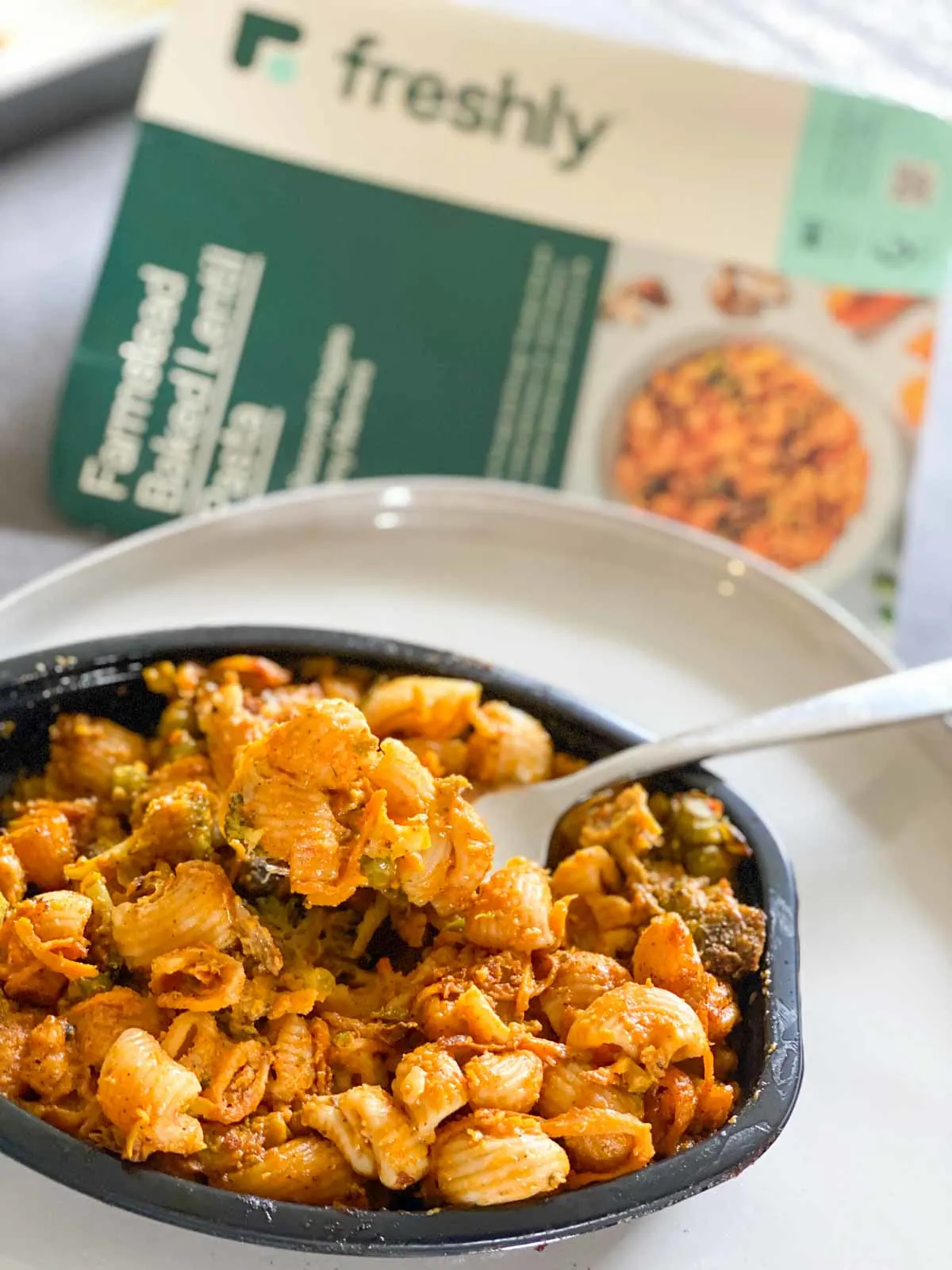 Freshly Farmstead baked lentil pasta with a bite on fork