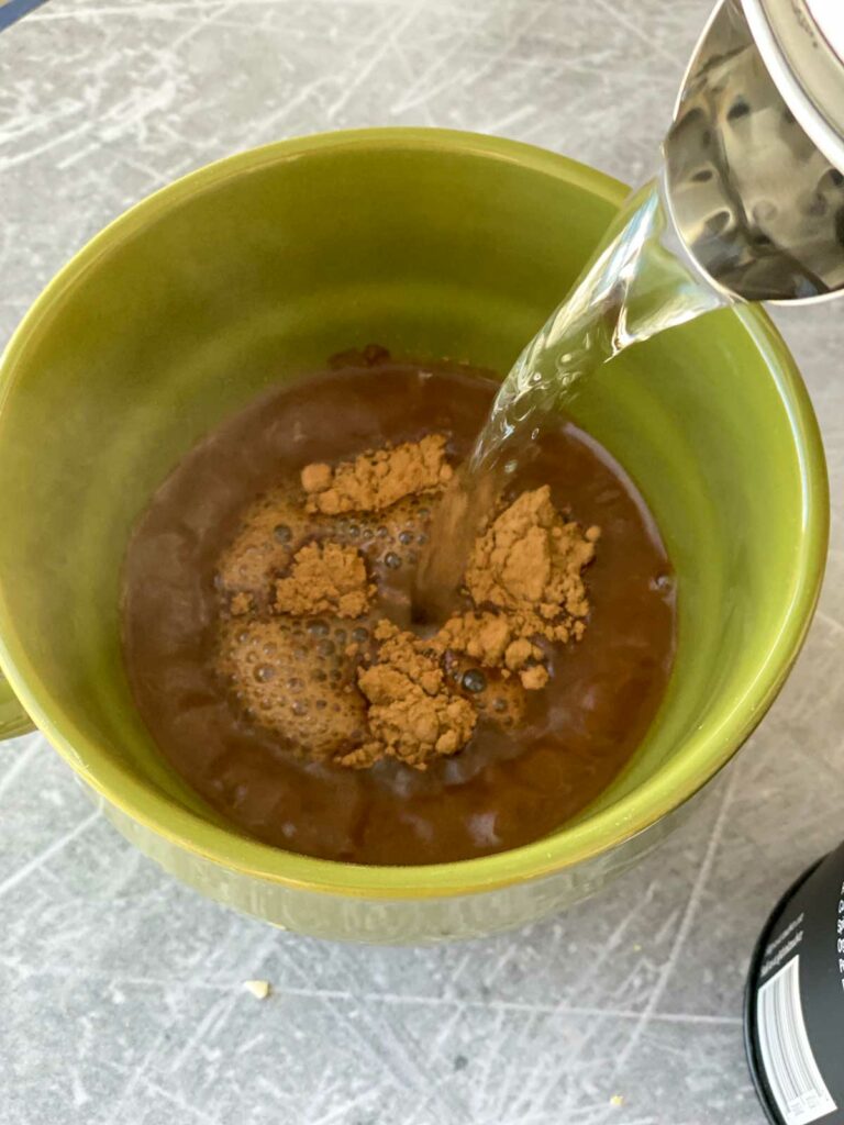 pouring hot water into mug with dry mud water
