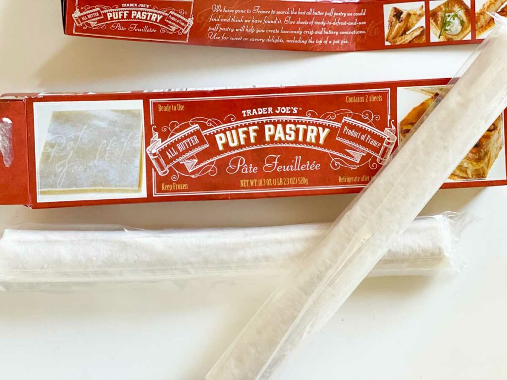 two frozen rolls of Trader Joe's puff pastry next to box