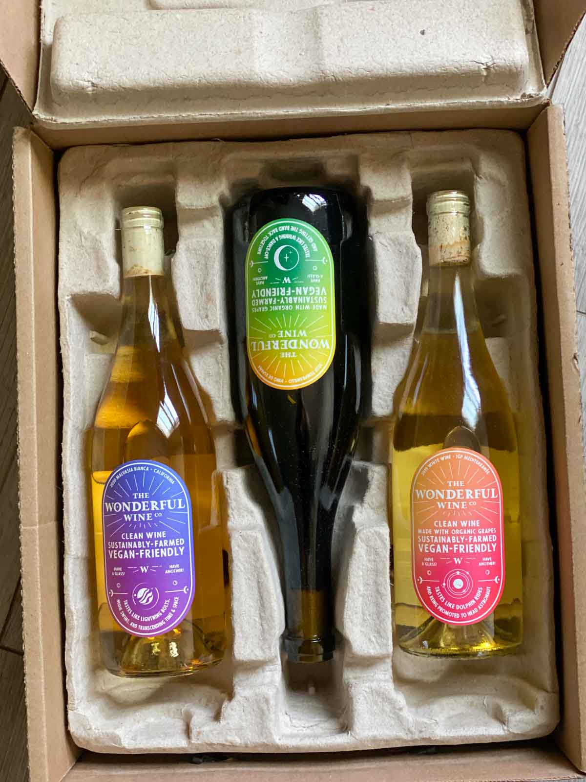 3 bottles of wonderful wine co in packaging - red, white, and orange