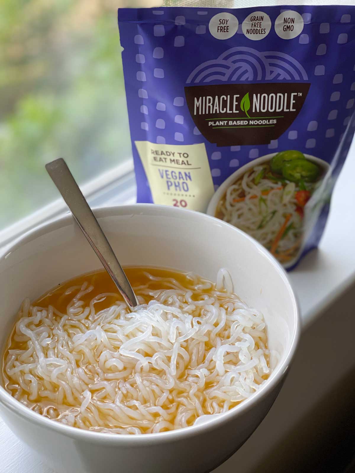 miracle noodle vegan pho in bowl next to package