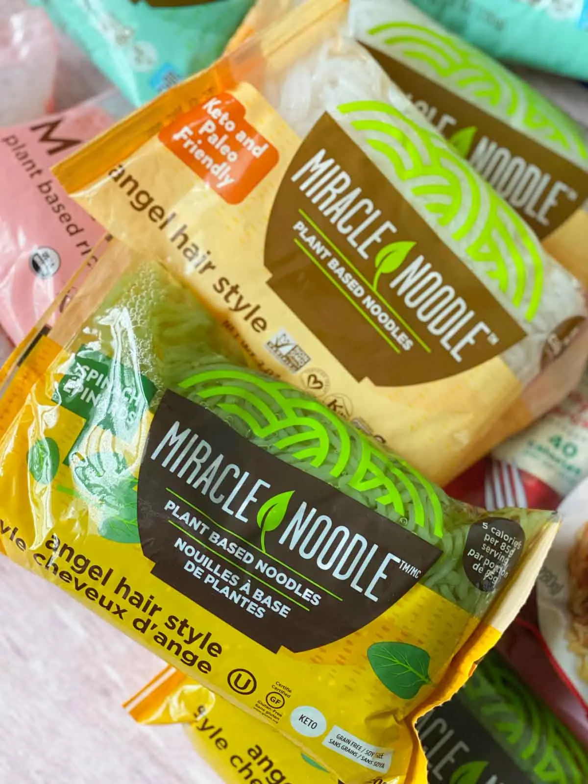 close up of original and spinach angel hair style Miracle Noodle package