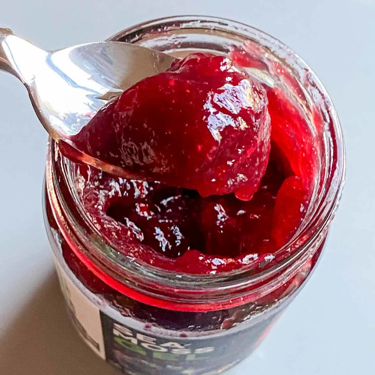 spoonful of dragonfruit sea moss gel taken out of open jar