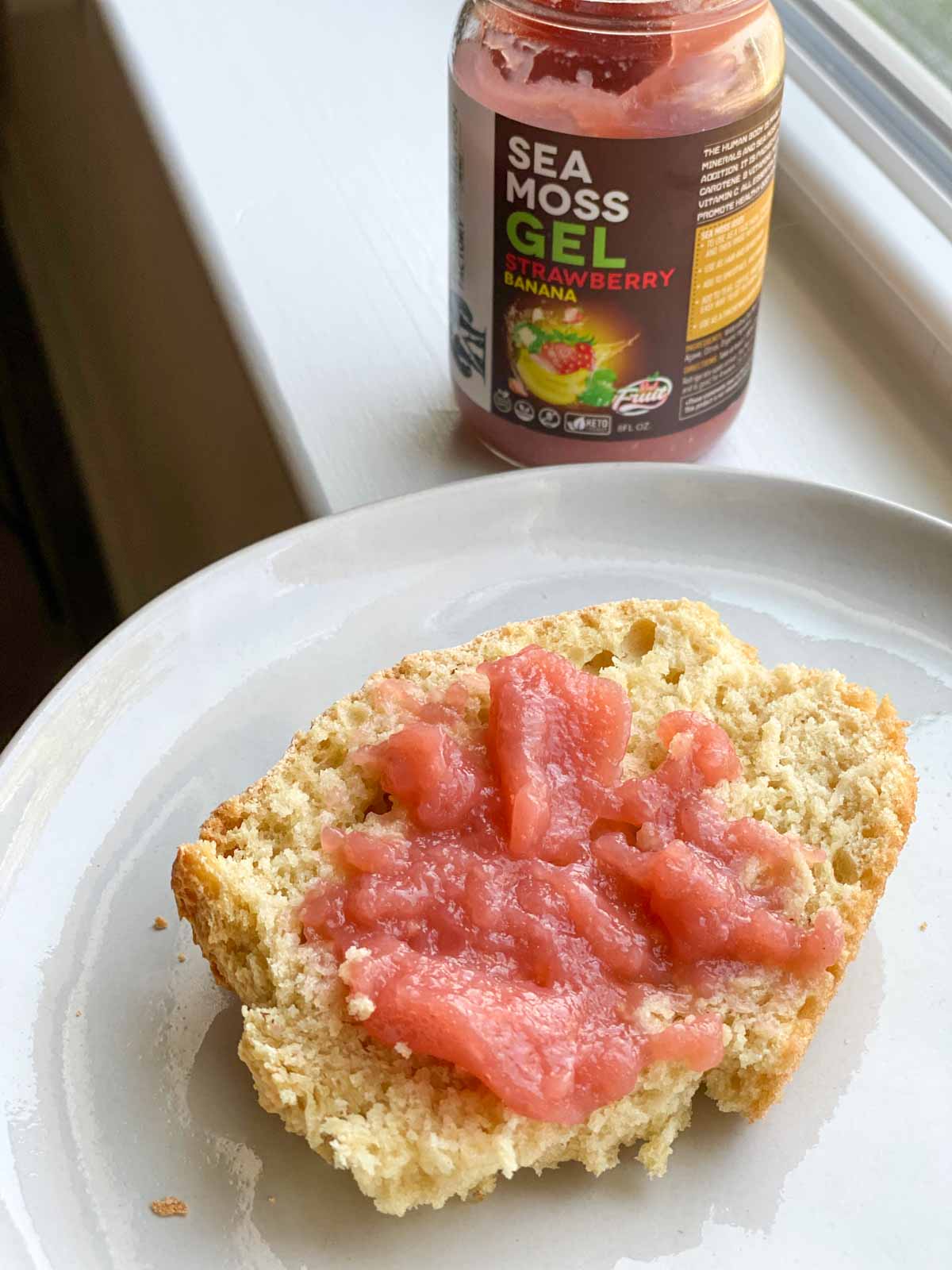 strawberry banana sea moss gel used as jam on piece of bread on white plate