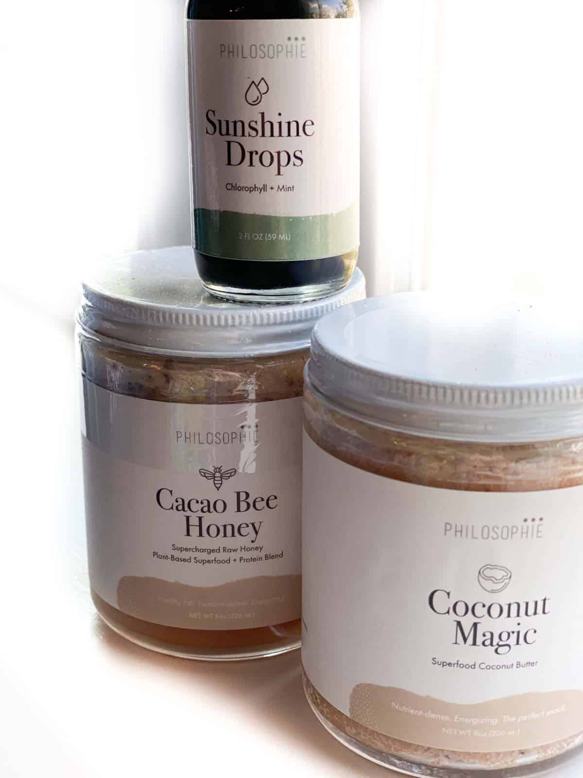 3 products from Philosophie superfoods line - cacao bee honey, coconut magic and sunshine drops