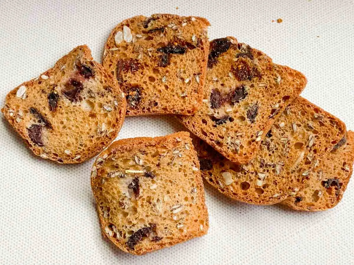 a close up of a handful of the Trader Joe's fig and olive crisps crackers