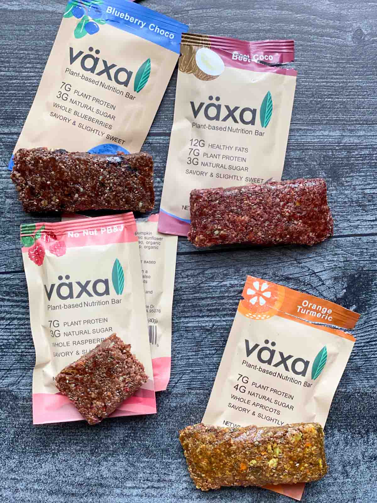 4 flavors of växa bars unwrapped next to their labels
