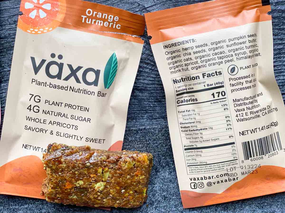 orange turmeric växa bar unwrapped next to nutrition facts