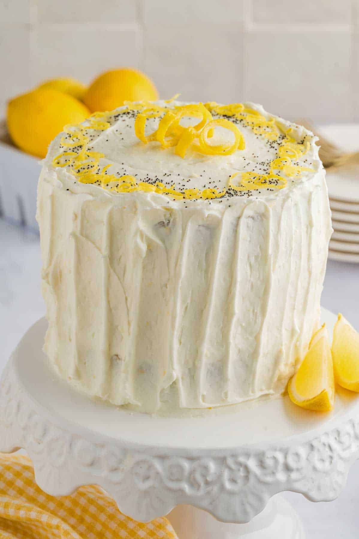 lemon poppyseed cake with icing and lemon zest on top.