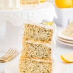a slice of the 3-layer lemon poppyseed cake on a plate.