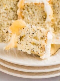 a closeup of a bite of lemon poppyseed cake on a fork.