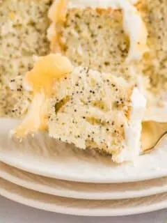 a closeup of a bite of lemon poppyseed cake on a fork.